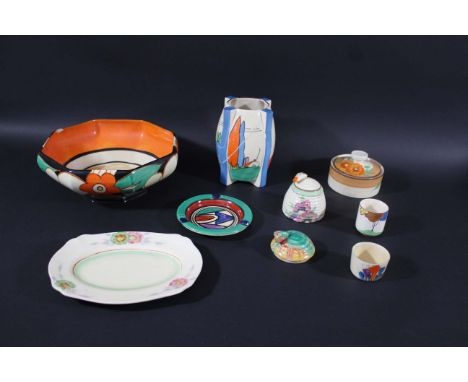 CLARICE CLIFF a mixed lot including a bee hive preserve pot and lid, a fin shaped vase in the Poplar design, an octagonal sha