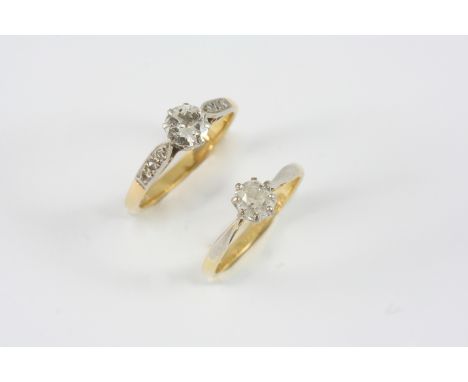 A DIAMOND SOLITAIRE RING the circular-cut diamond is set with three small diamonds to each shoulder, in 18ct. gold and platin