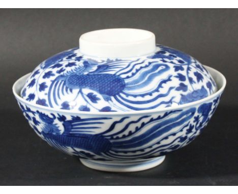 CHINESE BLUE AND WHITE PHOENIX BOWL AND COVER, Kangxi style but 19th century, painted with phoenix amongst flowering foliage,