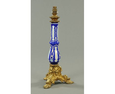 A Bohemian blue and white overlay glass lamp, with ormolu base.  Height excluding light fitting 46 cm. 