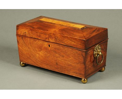 A Regency rosewood tea caddy, sarcophagus form, with two interior caddies, centre aperture and brass handles and feet.  Width
