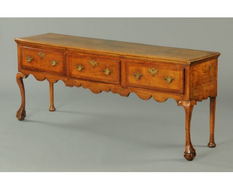 A George III oak dresser base, with moulded edge, three frieze drawers and raised on front cabriole legs terminating in claw 