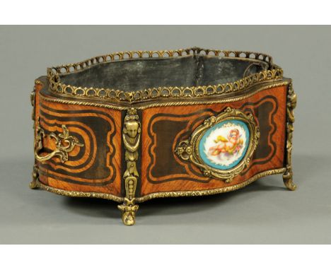 A Continental porcelain panelled planter, of shaped outline and with metal mounts.  Width 38 cm (see illustration).