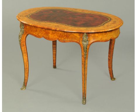 A Victorian walnut marquetry oval writing or centre table, with red gilt tooled leather centre surface, floral marquetry surr