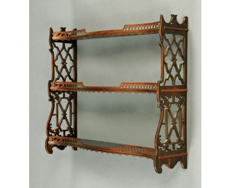 A wall hanging shelf unit, in the Chippendale style, with fretwork sides.  Width 79 cm. CONDITION REPORT: This lot is in very