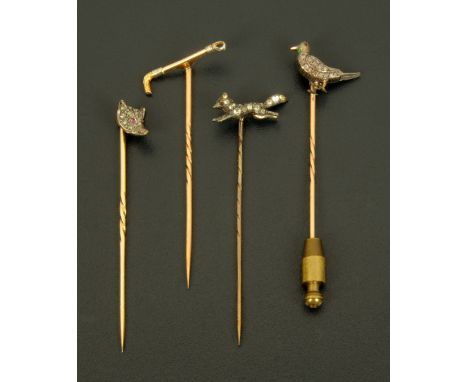 Four gold and silver hunting stick pins, fox mask, fox, crop and bird. CONDITION REPORT: The fox mask pin is in good order wi