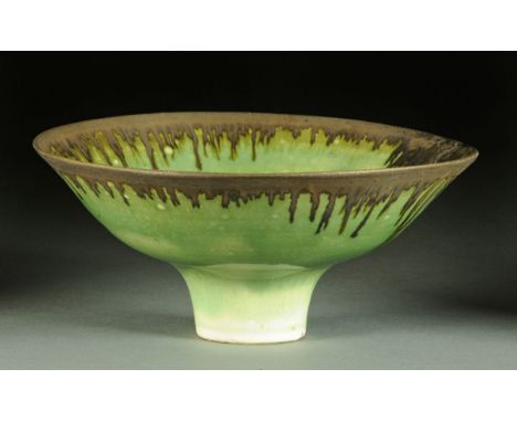 * Lucie Rie (1902-1995), a porcelain trumpet bowl, light apple green glaze and metallic dribbled border glaze, impressed "LR"