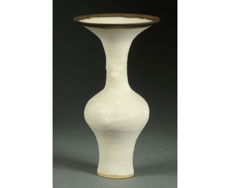 * Lucie Rie (1902-1995), a baluster vase, white glazed, with trumpet form neck and iron brown rim, impressed "LR" monogram.  