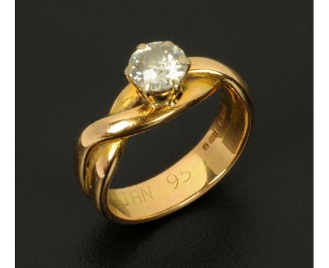 An 18 ct gold solitaire diamond ring, in twist setting, size K (see illustration).