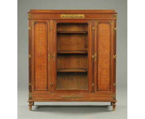 A French walnut and parquetry cabinet, early 20th century, with caddy top above a glazed door flanked on either side by a fur