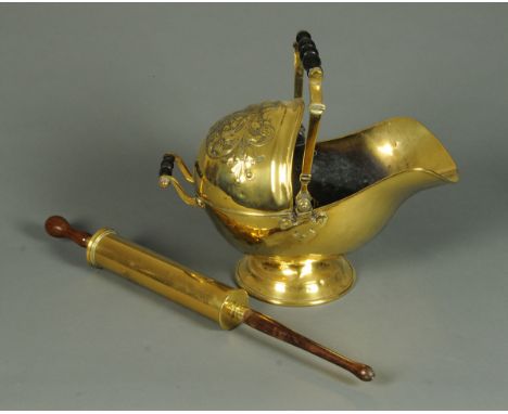 A 19th century embossed brass coal helmet, with twin carrying handles and an Arnold & Sons garden syringe.  