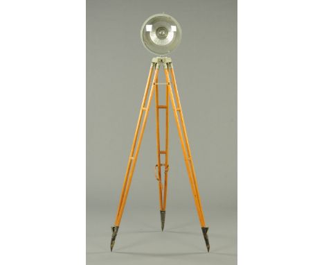 A circular spot lamp, raised on a wooden tripod base, probably a film lamp.  Diameter of lamp 35 cm, height of stand 165 cm (