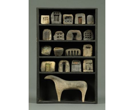 * A five shelf small black painted unit, with seventeen small arches and ceramic temple tablets and with stylised animal figu