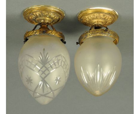 Two etched and cut glass ceiling light shades, each with metal mount, early 20th century.  Tallest 24 cm. 