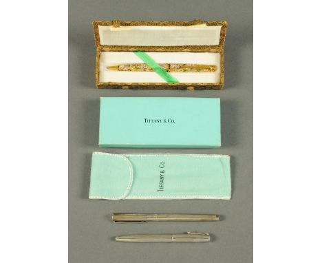 A Tiffany & Co. Sterling silver pen, with bag and box, a Chinese enamelled pencil in embroidered case and a silver pen. CONDI