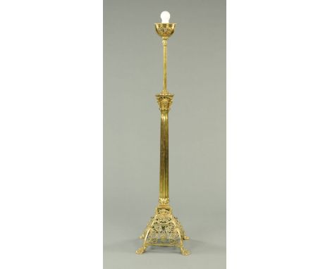 A Victorian brass lamp standard, with adjustable column, with ornate capital, fluted column and  openwork base raised on four