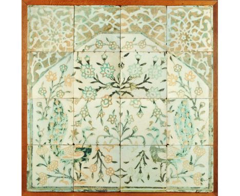 * A group of sixteen square tiles, Turkish/Persian, forming a mirhab, with pair of peacocks amongst blossom, early 20th centu