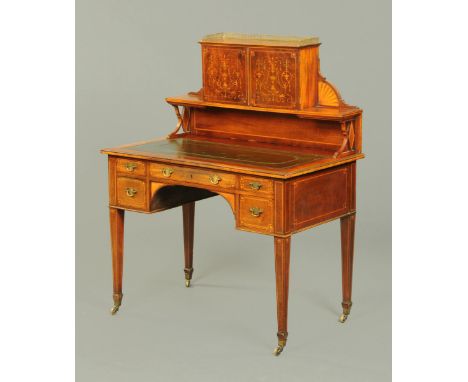 An Edwardian inlaid mahogany desk, the superstructure with cupboard and shelf and fitted with a green tooled leather writing 