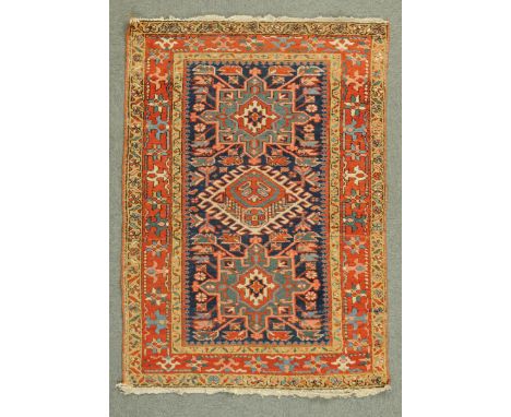 * A North East Persian rug, with centre rectangular panel with centre diamond flanked on either side by a further rectangular