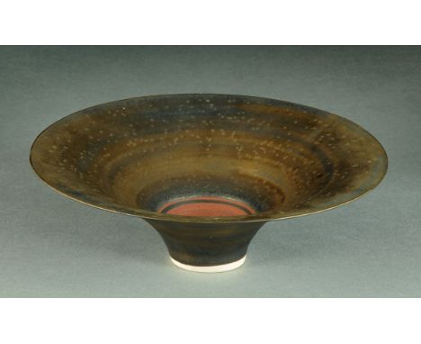 * Lucie Rie (1902-1995), a porcelain trumpet bowl, overall deep copper/brown glaze, impressed "LR" monogram within foot.  Dia