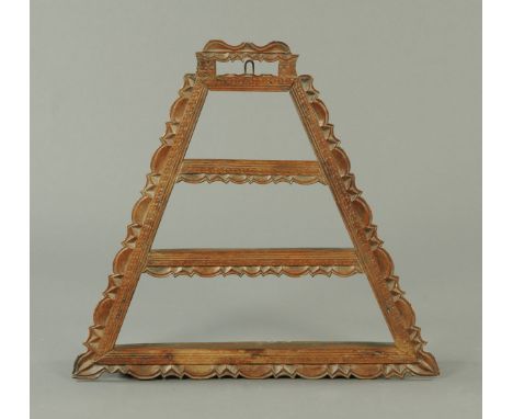 A late 19th century Continental carved wooden wall mounting shelf, triangular form.  Width 80 cm. 