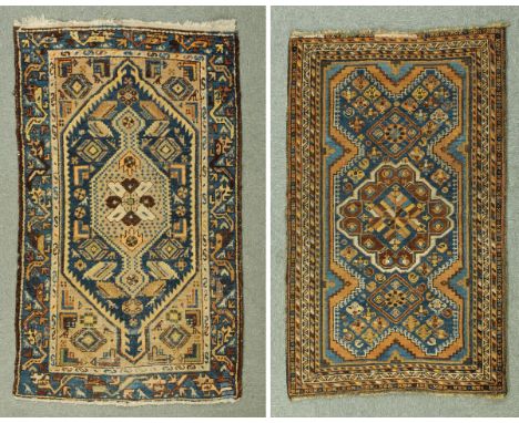 * A Hamadan rug, with centre rectangular panel with beige ground decorated in dark blue and with repeating line border with b