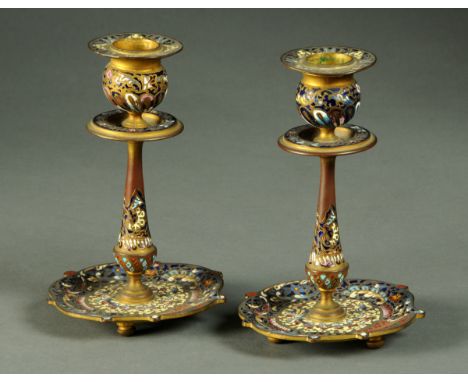 A pair of Champleve enamel candlesticks, late 19th/early 20th century.  Height 16 cm (see illustration).  CONDITION REPORT: B