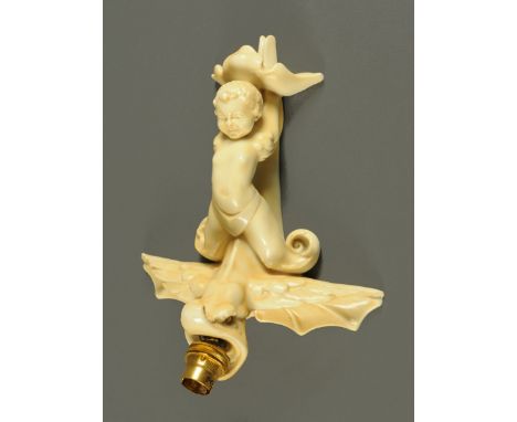 A Doulton Burslem wall lamp, in the form of a cherub and gargoyle.  Height 27 cm including light fitting.   CONDITION REPORT: