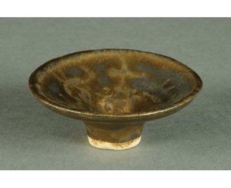 * Lucie Rie (1902-1995), a small porcelain trumpet bowl, gold lustre glaze and impressed "LR" monogram to foot.  Diameter 5.7