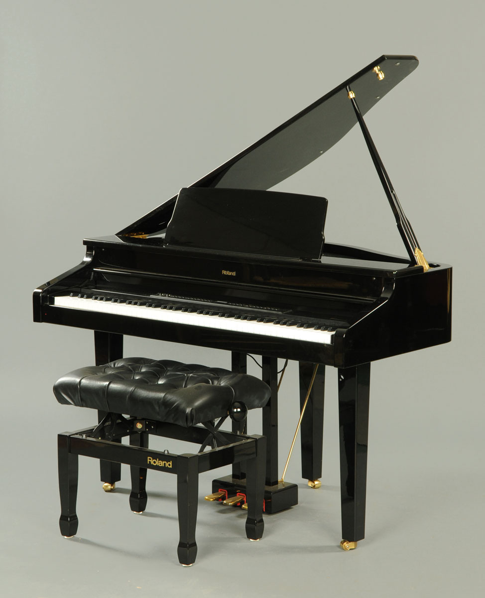 A Roland HP11 digital baby grand piano, in piano black with matching