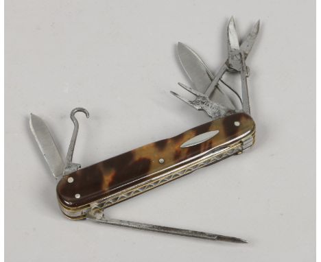 A 19th century multi tool folding pocket knife with tortoise shell scales and worked back, 7 accoutrements.