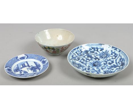 An 18th century Chinese provincial ceramic bowl decorated in coloured enamels and two Chinese blue and white dishes. Conditio