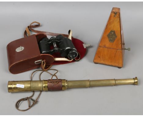 A brass and leather 3 drawer telescope along with a pair of Carl Zeiss 8 x 30 binoculars and a walnut cased metronome.