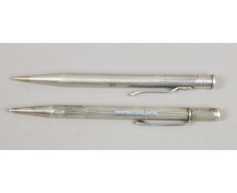 Two silver cased pencils with engine turned engraving assayed London 1946 and Birmingham 1961.