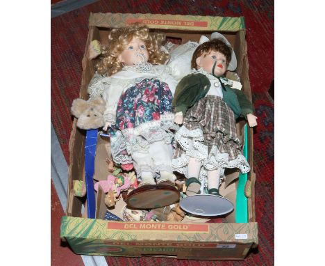 A box of collectors dolls and ceramic bear ornaments.