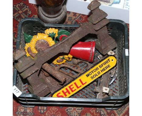 A collection of metalwares including Victorian boot scrape and door knocker, shell advertising sign, painted door stop and co