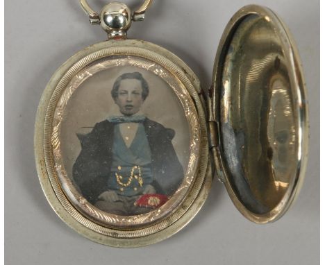 A Victorian gilt metal locket set with a Victorian portrait.