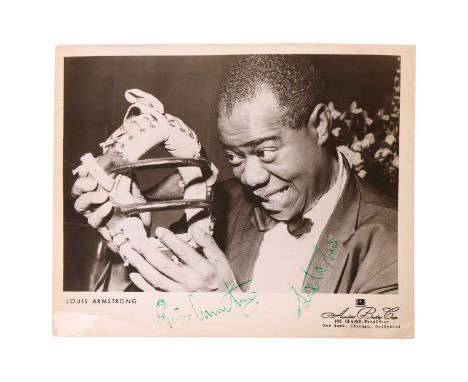 Louis Armstrong (1901-1971) American jazz trumpeter and vocalist. Autographed black and white publicity photograph – Signed i