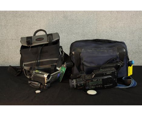Two electric handheld digital camcorders to include Hi8 camcorders and DV camera complete with accessories. H.15 W.35 D.10cm.
