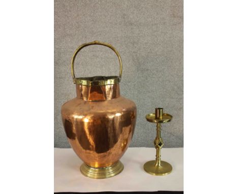 A 19th century Gothic Revival style brass candlestick, the central column with diamond knop raised on circular foot, together