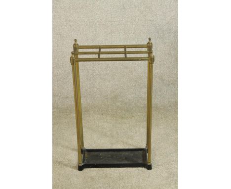 A 19th century brass and iron stick six section umbrella and stick stand raised on fluted supports. H.66cm. 