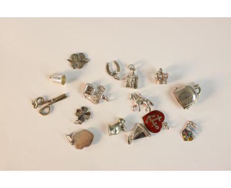 A collection of fifteen silver and white metal charms, including a thimble, scissors four leaf clovers, shields and animals. 