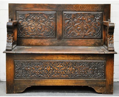 Carved oak monks bench, width 124cm, depth 51cm, height 94cm.