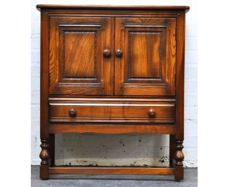 Ercol pot cupboard, a two door cupboard with drawer below, height 87cm, width 78cm, depth 43cm.