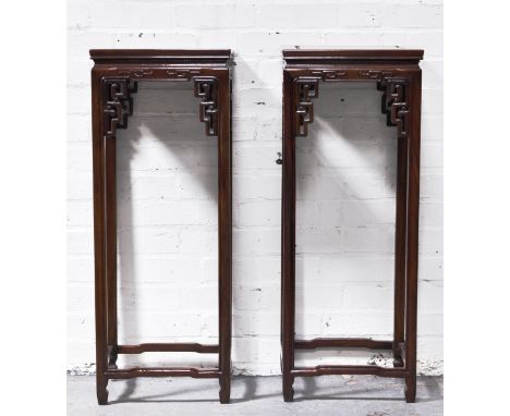 Pair of Chinese hardwood jardiniere stands, square platforms supported on a slender legs with pierced cloud scroll decoration
