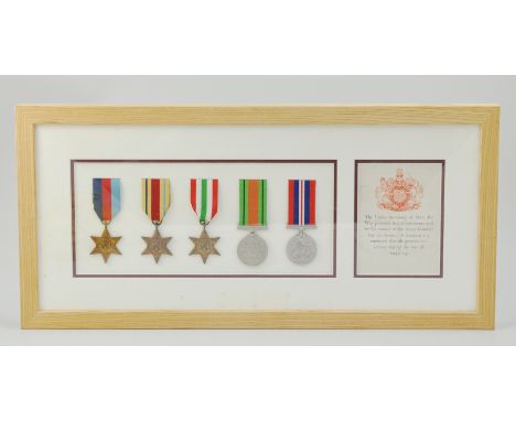 Framed set of WW2 medals, with a note saying "The Under Secretary of State for War presents his compliments by command of the