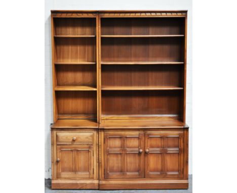 Ercol double bookcase, and a single unit bookcase, three shelves with cupboards below, height 198cm, width 150cm, depth 32cm.
