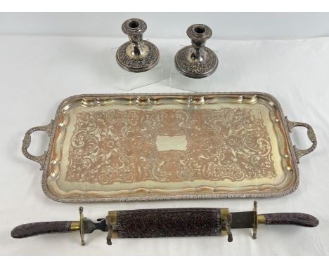 A large vintage silver plated tray with floral decoration (plate worn) together with a pair of matching candlesticks with flo