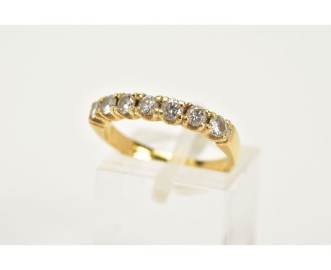 AN 18CT GOLD DIAMOND HALF ETERNITY RING, designed with seven claw set round brilliant cut diamonds, total estimated diamond w