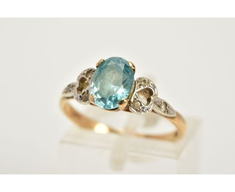 A 9CT GOLD TOPAZ RING, designed with a claw set, oval cut blue topaz, with openwork shoulders set with colourless topaz, hall